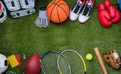 Various pieces of sporting equipment laid out on the grass